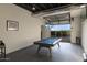 This game room features a stylish pool table and a glass garage door, perfect for entertaining at 24066 N 90Th Way, Scottsdale, AZ 85255