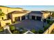 Spacious four-car garage with a large driveway and landscaping, providing ample parking and curb appeal at 24066 N 90Th Way, Scottsdale, AZ 85255