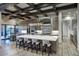 Gourmet kitchen featuring a large island with bar stools, stainless steel appliances, and wood floors at 24066 N 90Th Way, Scottsdale, AZ 85255