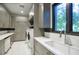 Convenient laundry room with ample storage, modern appliances, and a utility sink with plenty of light at 24066 N 90Th Way, Scottsdale, AZ 85255