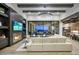 Cozy living room with fireplace, custom built-ins, and open layout to kitchen and outdoor area at 24066 N 90Th Way, Scottsdale, AZ 85255
