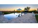 Serene infinity pool with lounge chairs and sunset views, offering a tranquil retreat for relaxation and enjoyment at 24066 N 90Th Way, Scottsdale, AZ 85255