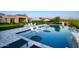 Luxury backyard with an infinity pool, lounge chairs, and manicured landscaping, creating a serene and inviting outdoor space at 24066 N 90Th Way, Scottsdale, AZ 85255