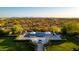 Stunning aerial view of a backyard with an infinity pool, lounge chairs, umbrellas, fire pit, and desert landscape at 24066 N 90Th Way, Scottsdale, AZ 85255