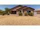 Expansive backyard featuring desert landscaping, mature trees, and covered patio at 25667 W Primrose Ln, Buckeye, AZ 85326