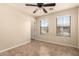 Bedroom featuring a ceiling fan, neutral paint, tile floors, and natural light from windows at 25667 W Primrose Ln, Buckeye, AZ 85326