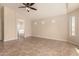 Spacious bedroom includes tile flooring, neutral walls, ceiling fan, and ensuite bath at 25667 W Primrose Ln, Buckeye, AZ 85326