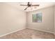 Cozy bedroom featuring tile floors, ceiling fan, and a bright window at 25667 W Primrose Ln, Buckeye, AZ 85326