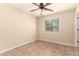 Bright bedroom with a ceiling fan, window with backyard views, and neutral walls at 25667 W Primrose Ln, Buckeye, AZ 85326