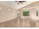 Bright bedroom featuring tile floors, vaulted ceilings, and multiple windows at 25667 W Primrose Ln, Buckeye, AZ 85326