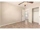 This inviting bedroom offers ample space, a ceiling fan, and a closet at 25667 W Primrose Ln, Buckeye, AZ 85326