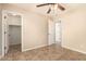 A spacious bedroom includes tile floors, a ceiling fan, and a closet at 25667 W Primrose Ln, Buckeye, AZ 85326