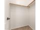Walk-in closet with built-in shelving and wood trim is ready for organizing at 25667 W Primrose Ln, Buckeye, AZ 85326