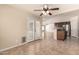 Open dining room boasts tile floors, ceiling fan, and French doors to backyard at 25667 W Primrose Ln, Buckeye, AZ 85326