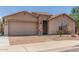 Single-story home featuring a two-car garage and low-maintenance desert landscaping at 25667 W Primrose Ln, Buckeye, AZ 85326