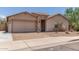 Single-story home featuring a two-car garage and low-maintenance desert landscaping at 25667 W Primrose Ln, Buckeye, AZ 85326