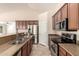 Kitchen with granite counters, stainless steel appliances, and views to the living room at 25667 W Primrose Ln, Buckeye, AZ 85326