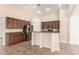 Modern kitchen with granite countertops, stainless steel appliances, breakfast bar, and pantry at 25667 W Primrose Ln, Buckeye, AZ 85326