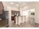 Kitchen features a breakfast bar, stainless appliances, tile floors, and plenty of cabinet space at 25667 W Primrose Ln, Buckeye, AZ 85326