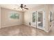 Bright living room with backyard access, tile floors, ceiling fan, and natural light at 25667 W Primrose Ln, Buckeye, AZ 85326