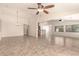 Open-concept living room with tile floors, vaulted ceiling, and seamless flow to kitchen at 25667 W Primrose Ln, Buckeye, AZ 85326