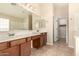 Bright main bathroom offers double sinks, a mirror, and large countertop space at 25667 W Primrose Ln, Buckeye, AZ 85326