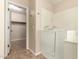 Accessible walk-in tub in main bath with doorway to walk-in closet at 25667 W Primrose Ln, Buckeye, AZ 85326