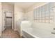 Spa-like bathroom features a soaking tub and shower combo, with a door to closet at 25667 W Primrose Ln, Buckeye, AZ 85326