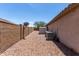 View of a side yard with rock landscaping, storage shed, and brick fencing at 25667 W Primrose Ln, Buckeye, AZ 85326