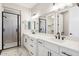 Bathroom features white cabinets, dual sinks and black hardware at 25894 W White Feather Ln, Wittmann, AZ 85361