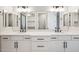 Bright bathroom featuring double sinks, undermount sinks, and modern fixtures at 25894 W White Feather Ln, Wittmann, AZ 85361
