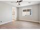 Spacious bedroom features hardwood floors, neutral paint and access to the en suite bathroom at 25894 W White Feather Ln, Wittmann, AZ 85361