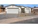 Charming home featuring a three car garage, desert landscaping, and stone accents at 25894 W White Feather Ln, Wittmann, AZ 85361