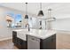 Modern kitchen island with stainless steel dishwasher and large single bowl sink at 25894 W White Feather Ln, Wittmann, AZ 85361