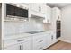 Contemporary kitchen showcasing stainless steel appliances and white cabinets at 25894 W White Feather Ln, Wittmann, AZ 85361