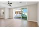 Bright living area features hardwood floors and sliding glass doors to the backyard at 25894 W White Feather Ln, Wittmann, AZ 85361