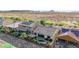 Aerial view showcasing a backyard with pool, patio, lush landscaping, and solar panels on adjacent rooftops at 31107 N 27Th Ave, Phoenix, AZ 85085