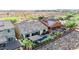 Aerial view showcases a backyard with pool, patio, desert landscaping, and solar panels on neighboring rooftops at 31107 N 27Th Ave, Phoenix, AZ 85085