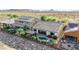 Aerial view of a backyard with a pool, patio, desert landscaping, and solar panels on rooftops in the distance at 31107 N 27Th Ave, Phoenix, AZ 85085