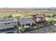 Aerial view showcases a backyard with a pool, covered patio, desert landscaping, and neighboring houses with solar panels at 31107 N 27Th Ave, Phoenix, AZ 85085