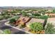 Suburban homes with desert landscaping, solar panels, and tile roofs against a mountain backdrop, from an aerial view at 31107 N 27Th Ave, Phoenix, AZ 85085