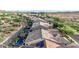 Stunning aerial view of a neighborhood featuring houses with pools and solar panels in a sunny, desert landscape at 31107 N 27Th Ave, Phoenix, AZ 85085