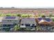 Aerial view of the backyard featuring a pool, covered patio, desert landscaping, and solar panels on rooftops nearby at 31107 N 27Th Ave, Phoenix, AZ 85085