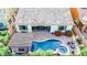 Aerial view of a well-maintained backyard featuring a pool, spa, covered patio, and desert-friendly landscaping at 31107 N 27Th Ave, Phoenix, AZ 85085