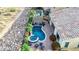 Aerial view of a backyard featuring a pool, spa, covered patio, and carefully manicured desert landscaping at 31107 N 27Th Ave, Phoenix, AZ 85085