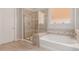 This bathroom has a soaking tub and glass enclosed shower at 31107 N 27Th Ave, Phoenix, AZ 85085
