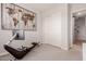 Neutral bedroom with modern exercise equipment, world map art, and closet with mirrored doors at 31107 N 27Th Ave, Phoenix, AZ 85085