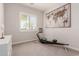 Modern home gym featuring an exercise machine and natural light from a large window at 31107 N 27Th Ave, Phoenix, AZ 85085