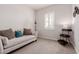 This flex room features a sofa and great natural light through plantation shutters at 31107 N 27Th Ave, Phoenix, AZ 85085