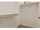 Walk-in closet with wood shelves and rod for clothing storage at 31107 N 27Th Ave, Phoenix, AZ 85085